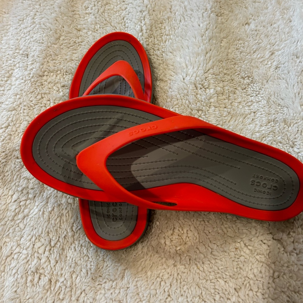Crocs flip flops women’s size 11  bright orange/coral. Great preowned condition.